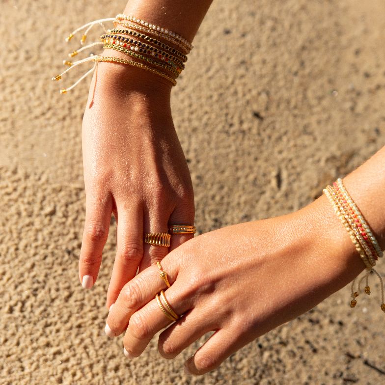 Add a pop of sparkle to your look with our Dazzle Beads Adjustable Bracelets! These trendy bracelets, made with seed beads and a touch of gold, are perfect for layering or wearing solo.