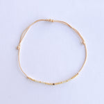 Add a pop of subtle color to your style with our Gleam Beads Adjustable Bracelets. Featuring different colors and gold beads on a silky cotton string, these adjustable bracelets are perfect for layering, with five colors available to create your unique combinations. Lightweight and comfortable, they’re ideal for everyday wear and special occasions alike. Don't forget to check our matchy anklets too!
