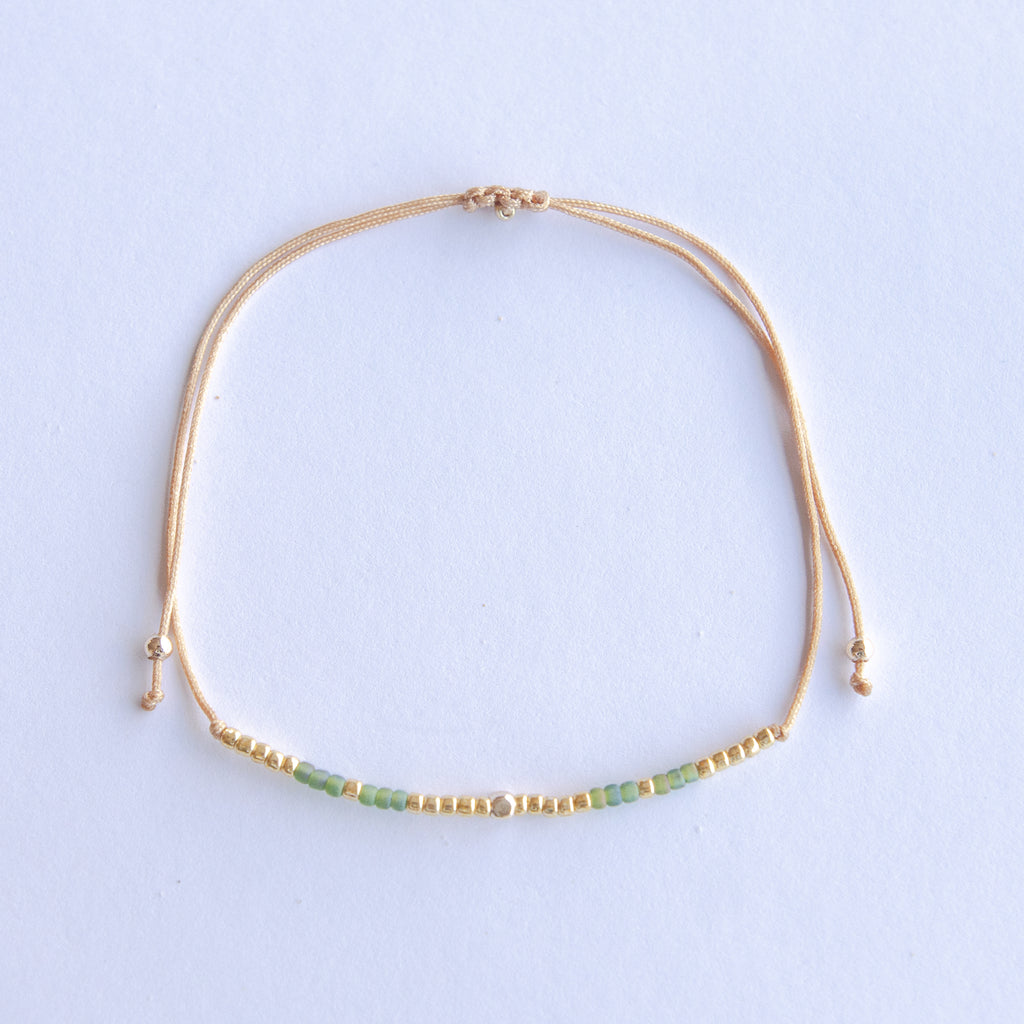 Add a pop of subtle color to your style with our Gleam Beads Adjustable Bracelets. Featuring different colors and gold beads on a silky cotton string, these adjustable bracelets are perfect for layering, with five colors available to create your unique combinations. Lightweight and comfortable, they’re ideal for everyday wear and special occasions alike. Don't forget to check our matchy anklets too!