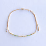 Add a pop of subtle color to your style with our Gleam Beads Adjustable Bracelets. Featuring different colors and gold beads on a silky cotton string, these adjustable bracelets are perfect for layering, with five colors available to create your unique combinations. Lightweight and comfortable, they’re ideal for everyday wear and special occasions alike. Don't forget to check our matchy anklets too!