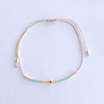 Add a pop of subtle color to your style with our Gleam Beads Adjustable Bracelets. Featuring different colors and gold beads on a silky cotton string, these adjustable bracelets are perfect for layering, with five colors available to create your unique combinations. Lightweight and comfortable, they’re ideal for everyday wear and special occasions alike. Don't forget to check our matchy anklets too!