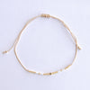Add a pop of subtle color to your style with our Gleam Beads Adjustable Bracelets. Featuring different colors and gold beads on a silky cotton string, these adjustable bracelets are perfect for layering, with five colors available to create your unique combinations. Lightweight and comfortable, they’re ideal for everyday wear and special occasions alike. Don't forget to check our matchy anklets too!