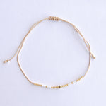 Add a pop of subtle color to your style with our Gleam Beads Adjustable Bracelets. Featuring different colors and gold beads on a silky cotton string, these adjustable bracelets are perfect for layering, with five colors available to create your unique combinations. Lightweight and comfortable, they’re ideal for everyday wear and special occasions alike. Don't forget to check our matchy anklets too!