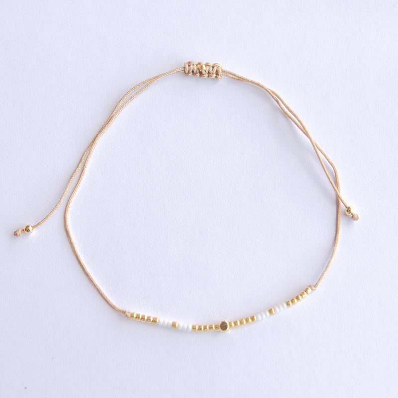 Add a pop of subtle color to your style with our Gleam Beads Adjustable Bracelets. Featuring different colors and gold beads on a silky cotton string, these adjustable bracelets are perfect for layering, with five colors available to create your unique combinations. Lightweight and comfortable, they’re ideal for everyday wear and special occasions alike. Don't forget to check our matchy anklets too!