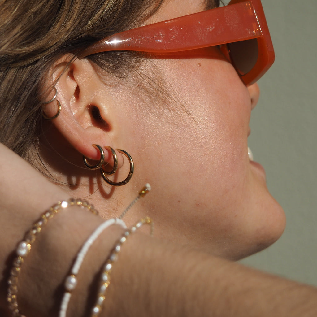 These Classic Hoops are available in both silver and gold and in a range of sizes and widths, so you can create your perfect earring combination. Don't forget to check our thicker version too.