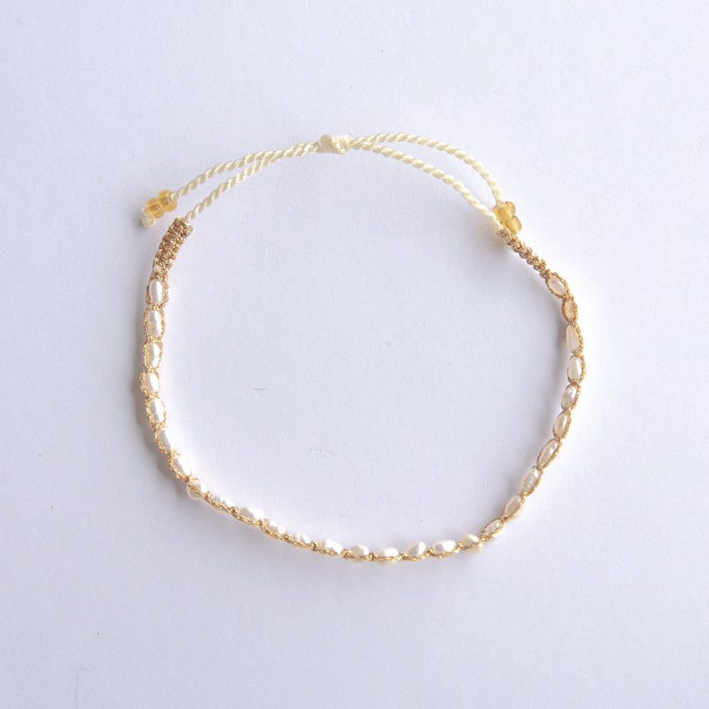 Elevate your style with our Gold String Bracelet featuring genuine freshwater pearls. This trendy bracelet is perfect for adding a touch of coastal charm to any outfit, whether at the beach or in the city. Made with durable, high-quality materials, it offers both style and comfort with its adjustable fit. Don’t forget to check out our matching anklet to complete your look!