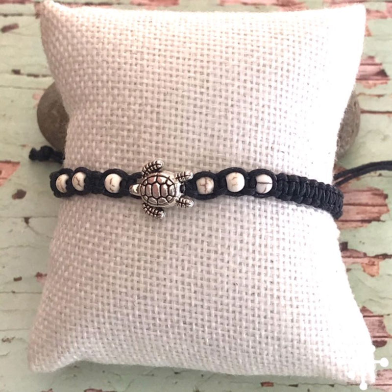Hand made bracelet with turtle pendant on black cord with cream beads