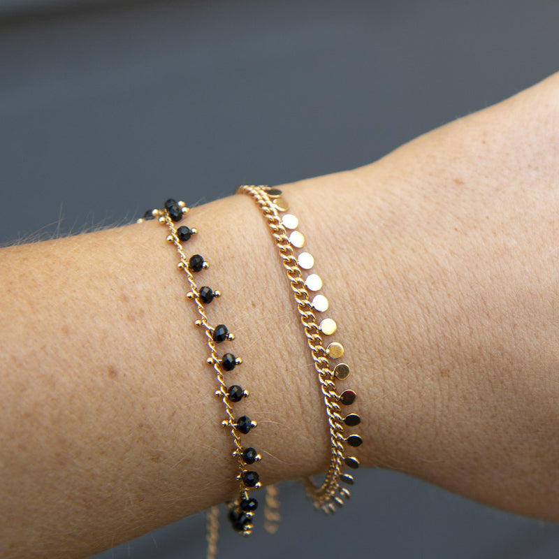 Gold bracelets with black beads and mini disc charms