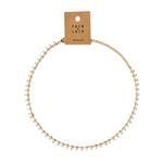 Gold necklace with white beads